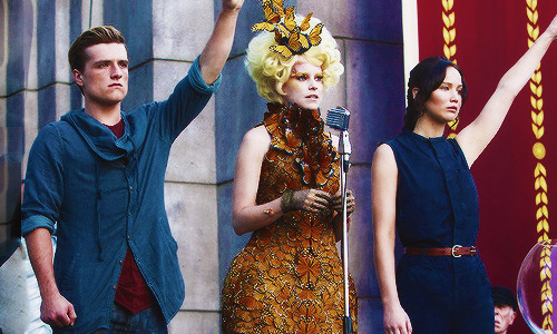  I think the biggest contrast here is Effie. Katniss and Peeta are about to relive the events they barely survived, again but here you can really see that Effie is concerned, worried and somewhat distraught, compared to the first picture. I can really
