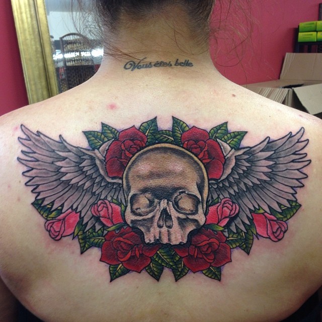 Skull wings low back tattoo