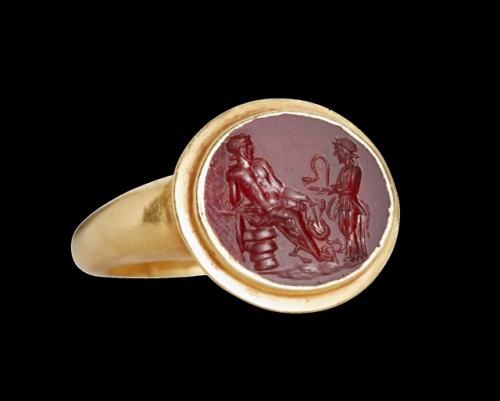 Ancient Roman gold ring with a carnelian intaglio of the gods Asclepius and Hygeia, dated to the 2nd