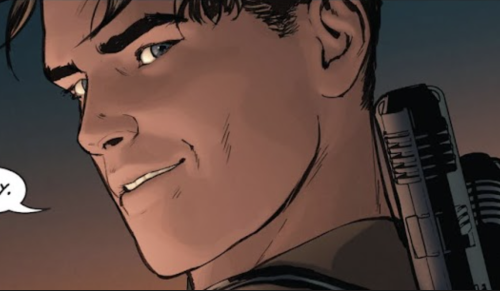 Close-up of Dick's face, turned to the side and grinning.