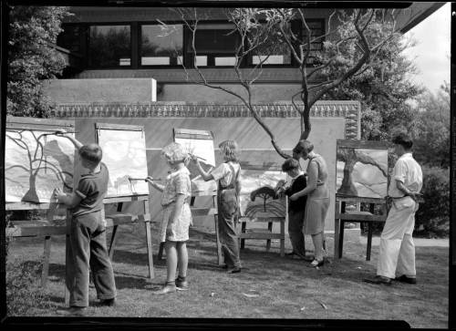 Children painting during an art class at Barnsdall Park, Los Angeles, 1930. In the background is the