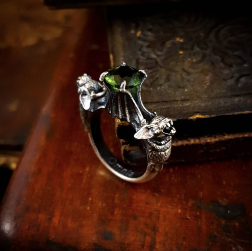 Nocturne ring - two dainty bats clutch a sparkling gemstone, each holding another tiny gem in their 