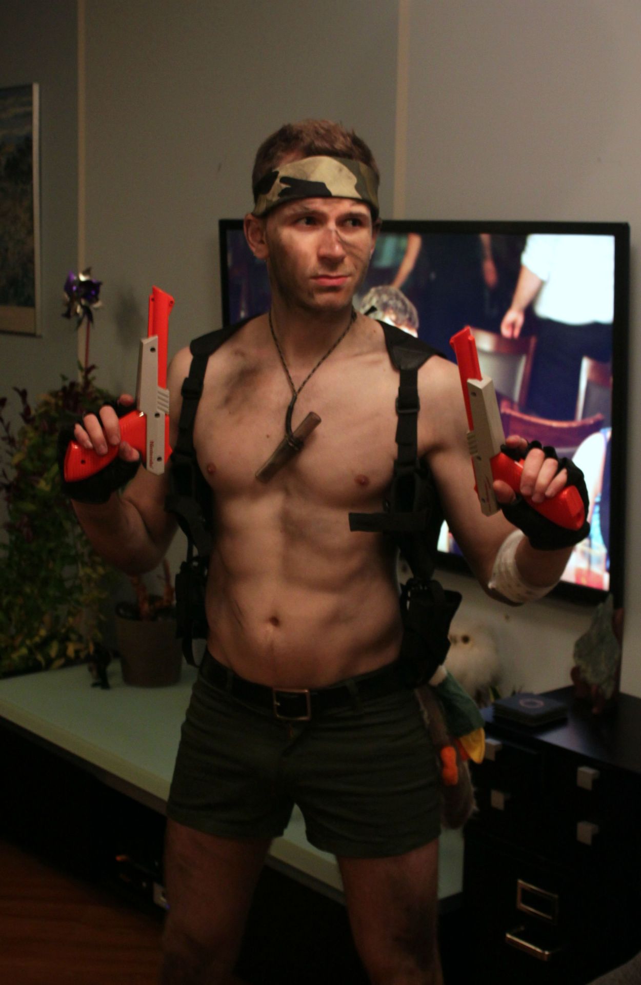 Camo headband, Lara Croft inspired short shorts with weapon holsters, and NES Zapper