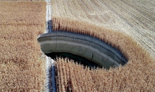 iamoutofideas:unsubconscious:A drone photo shows one of several sinkholes that opened up under a field in the Karapinar district of Konya, Turkey, on September 28, 2018. Photo by Abdullah Coskun. new hole just dropped