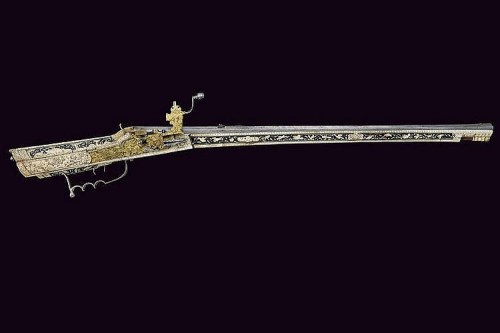 A beautiful 17th century wheel-lock rifle decorated with bone, silver, and gold.  Most likely G