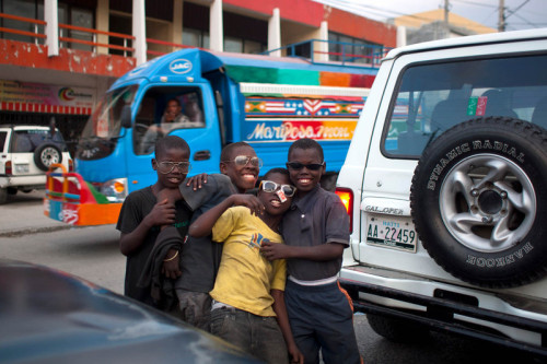 Street children stop to pose for a picture as they work along Delmas Street in Port-au-Prince, Haiti