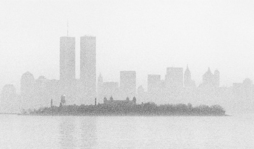 Ellis Island (from Liberty State Park), 1989, with New York skyline/World Trade Center in background.