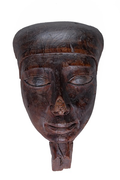 Wooden face mask from coffin, flat backed with dowel holes for attachment to lid and remains of inte
