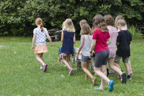 Montessori School children walking and sharing their dreams from their new Dream Scroll in their school garden. Photo Credit Shawn Caldwell