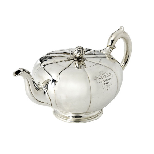 A Silver Teapot by Robert Garrard, In the form of a stylised melon with reeded sides, the finial in 