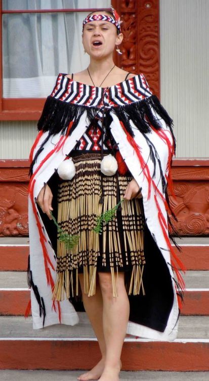 A Maori woman chants in traditional regalia.