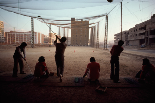 A temporary vacant lot serves as driving range amid high rise buildings, December 1979.Photograph by