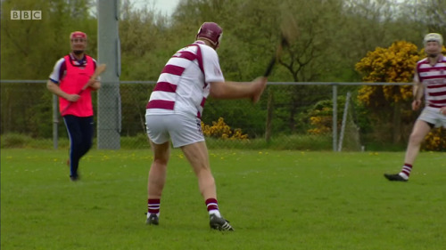 Adrian Chiles playing a game of hurling in “Christine & Adrian’s Friendship Test” s1e02