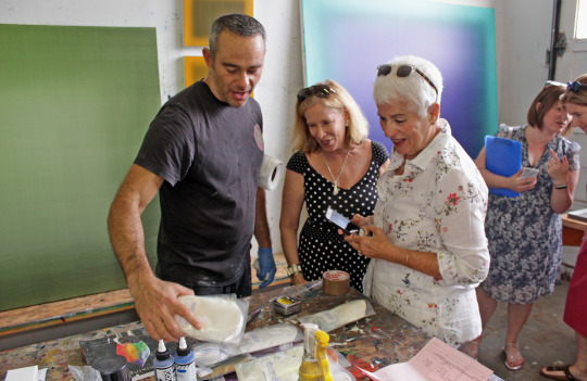 Artist Eric Freeman and 2019 East End Studio Tour attendees in his studio.