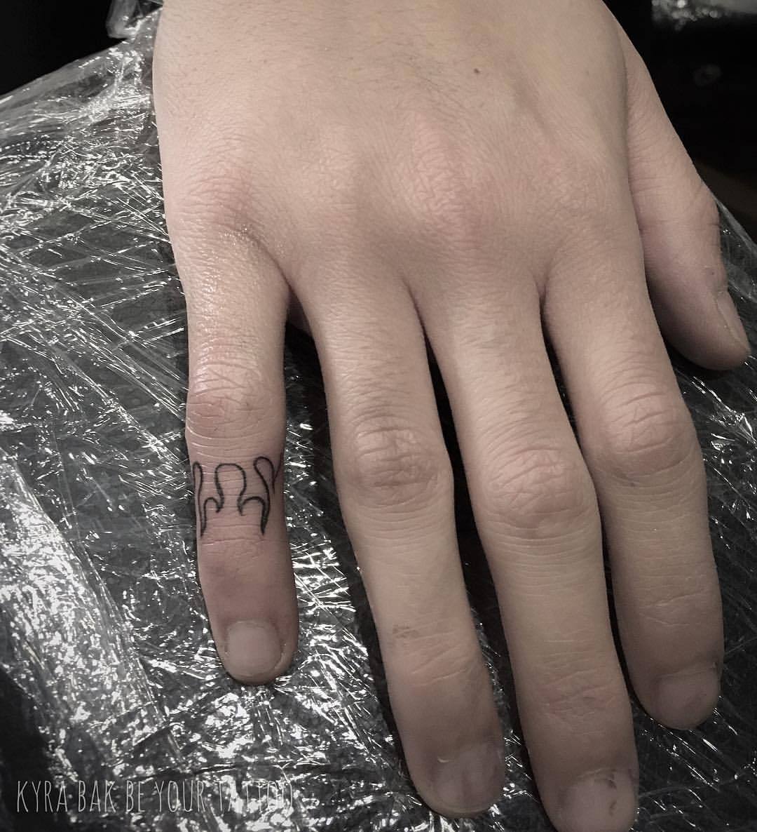 Hand poked fire tattoo on the finger