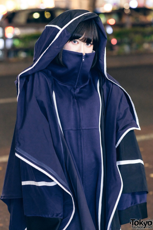 16-year-old Japanese student Kana on the street in Harajuku wearing a hooded coat by the futuristic 