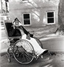 Diane Arbus - Masked Woman In A Wheelchair, Pa, 1970.