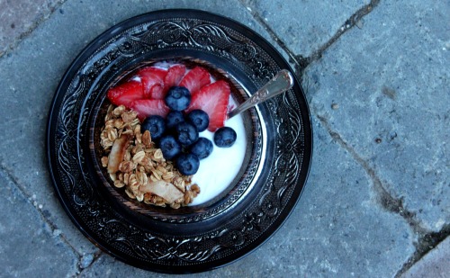 maple coconut granola with blueberries strawberries and soy yoghurt. Having such a nice breakfast is