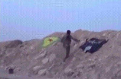 kropotkindersurprise: October 18 2014 - A Kurdish fighter plants the YPG flag after recapturing
