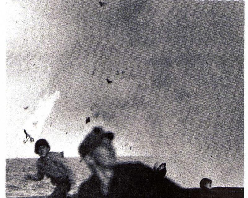 talesofwar:  US sailors are taking cover from the debris of a Kamikaze plane that