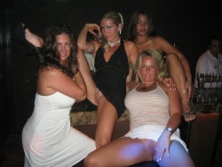 carelessinpublic:  Group of ladies in short dresses inside a bar and showing their pussy