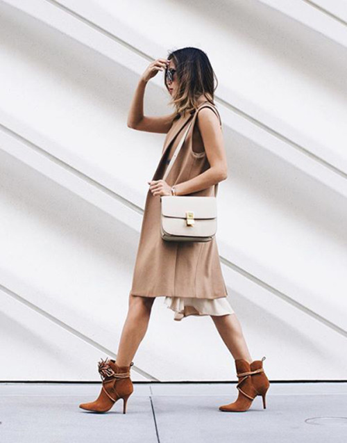 justthedesign: Aimee Song looks casual and elegant in a tan sleeveless jacket and brown ankle boots