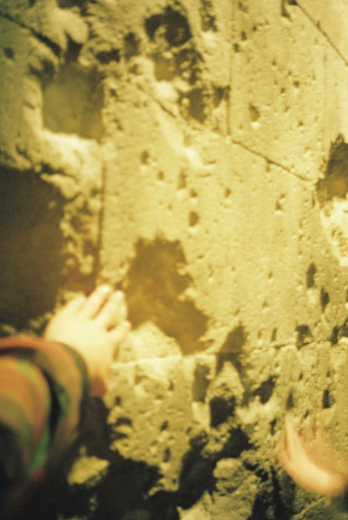 consequences of the civil war bombings at Sant Felip Neri // Carmen posing on the wall.Barcelona, Ma