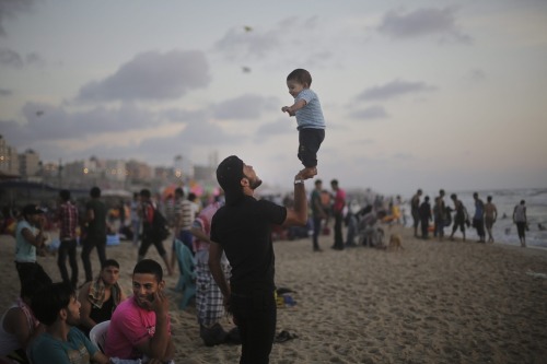 A summer day on a beach in Gaza1. A Palestinian man plays with his son at the beach in the west of G