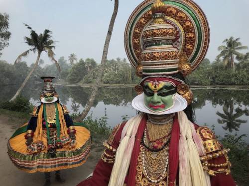 During a classical Indian dance known as a kathakali, participants combine elaborate masks and costu