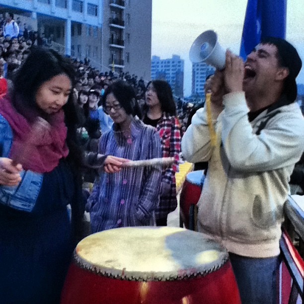 Cheering on the team at the football match with my Chinese teacher 加油!(jia you!)