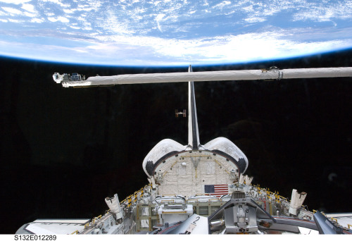 fuckyeahspaceshuttle:The International Space Station (center) appears very small from the point of v