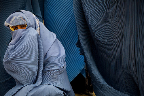 letswakeupworld:  A woman tries to keep warm as she waits at a food distribution site for widows in Kabul, Afghanistan.