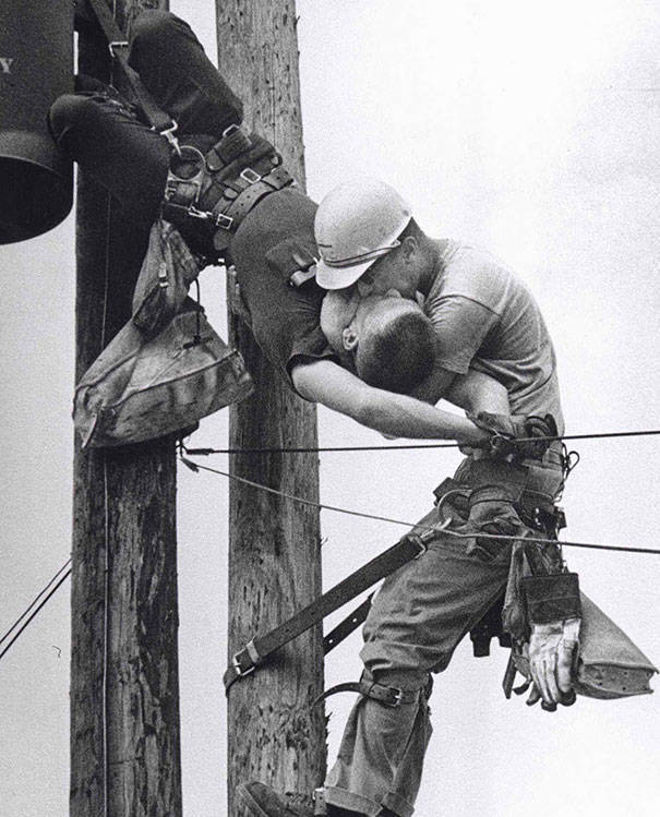 A utility worker giving mouth-to-mouth to a co-worker after he accidentally touched