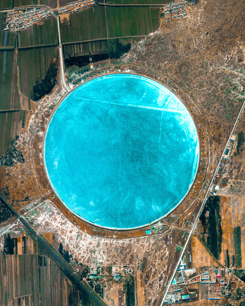 dailyoverview: Clear blue water fills the Pingyuan Reservoir, located just outside of Zhaodong City 