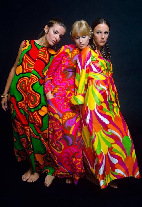 isabelcostasixties:  Psychedelic long dresses, Mademoiselle Magazine 1967.  Three models stand close together wearing brightly colored maxi dresses; from left to right: sleeveless dress with swirl pattern in green, orange, red and black by Fifth Avenue