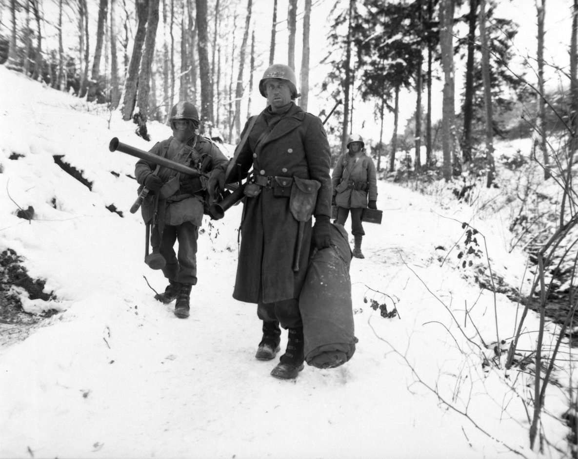 bag-of-dirt:
“U.S. Army combat engineers of “B” Company, 101st Engineer Battalion, trudge through the densely wooded Ardennes forest after holding a woodland position all night against a German counter attack during the Battle of the Bulge. Near...