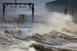 untrustyou:  A train passed along the coast in Saltcoats, Scotland, Friday Jan. 3, 2014. (Danny Lawson/PA/Associated Press) 