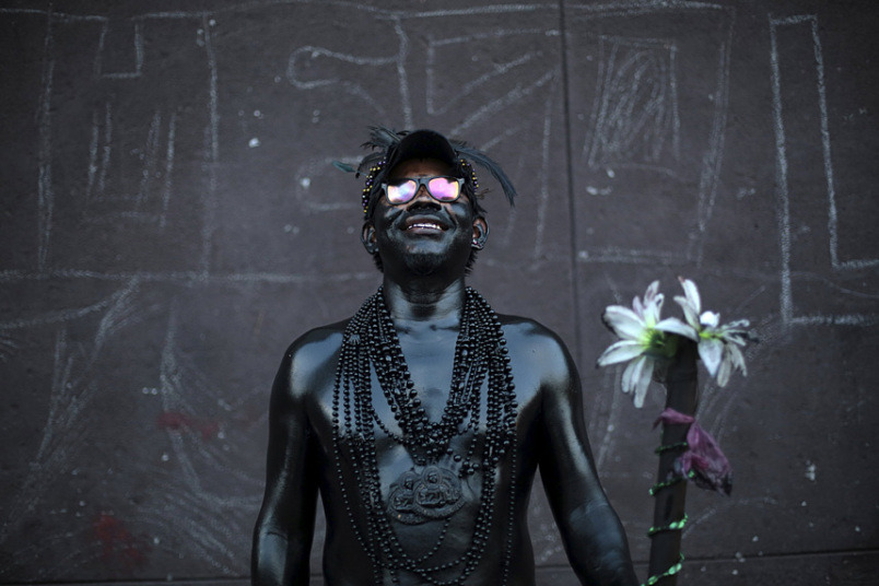 leroi:  A man covered in motor oil poses for a picture during celebrations honouring