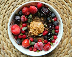 seedsnsmiles:  Cocoa banana baked oatmeal topped with flaxseed, mixed frozen berries, pumpkin seeds, organic crunchy peanut butter and a drizzle of maple syrup. :)