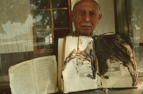 balkanmuslims:Kosovo, July 1999, A Qur’an salvaged from the mosque Haji Vesseyeli, set on fire by th