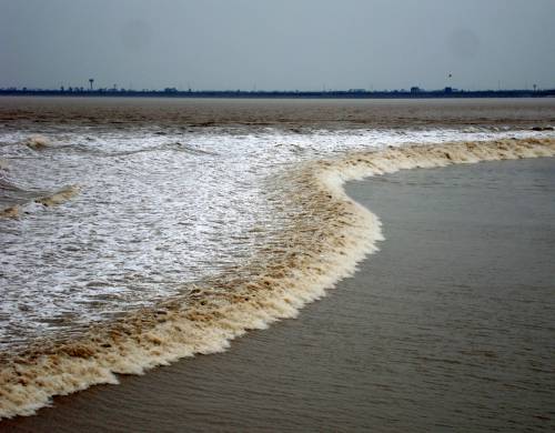 Silver Dragon Tidal BoreWhen a river broadens into an open area or an estuary as it enters the ocean