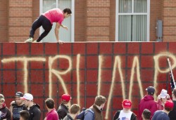 dboybaker:  So there was a Trump rally at my school a few weeks ago. They erected a 9 foot wall outside our Union Building. In an attempt to devalue their display, I jumped over it. Just found this image of the event.Firstly I’d like to say a wall will