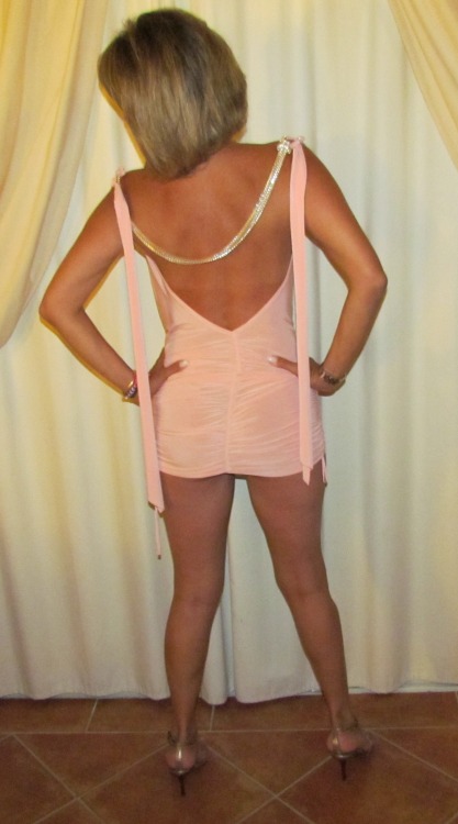 myhotshywife2:  Dressed as a slut for a swinging party. Tight pink dress highlights her hot body. Sorry for the poor quality resolution, guys. 