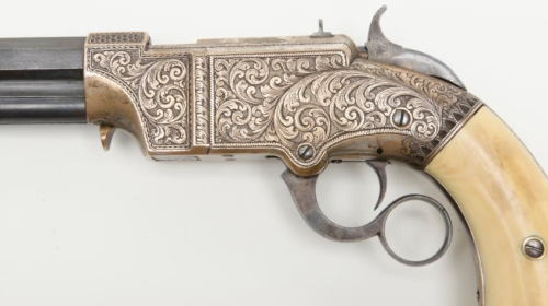 Engraved pair of Volcanic pistols with Mexican eagle and snake carved ivory grips, mid 19th century.