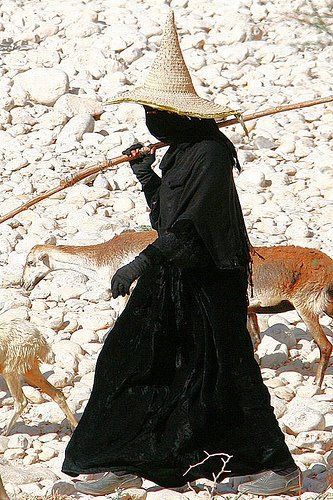 Women in Hadramaut, Yemen wear an all black abaya and conical straw sunhat called a madhalla when wo