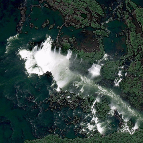 dailyoverview: Iguazu Falls, the largest waterfall system in the world, is located on the border of 