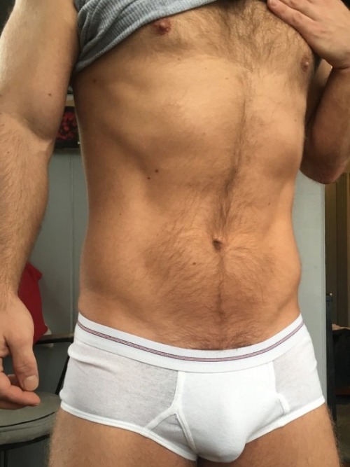 white-briefs-lover: So nice that he lifts his tanktop so that we can see his hot hairy chest and his