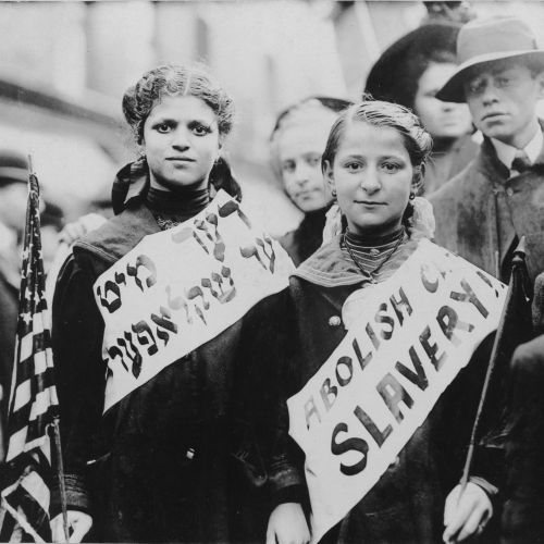 jewishvirtuallibrary:Two girls at a labor parade in New York wearing banners that say ‘Abolish