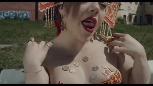 Olympia Ivleva of the fabulous Russian cultural terrorism group LITTLE BIG takes a golden bath in their video “Give me your money”.