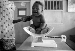 africanstories:  Ugandan baby being weighed